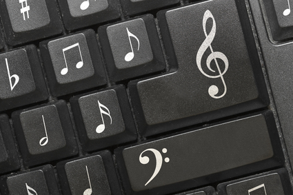 The keyboard of a computer with notes.